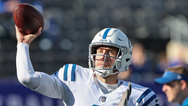 Colts backup quarterback Nick Foles warms up before a game.